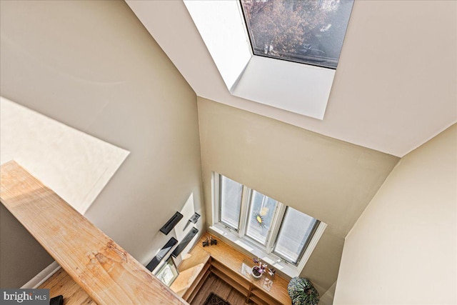 interior space with wood-type flooring and vaulted ceiling