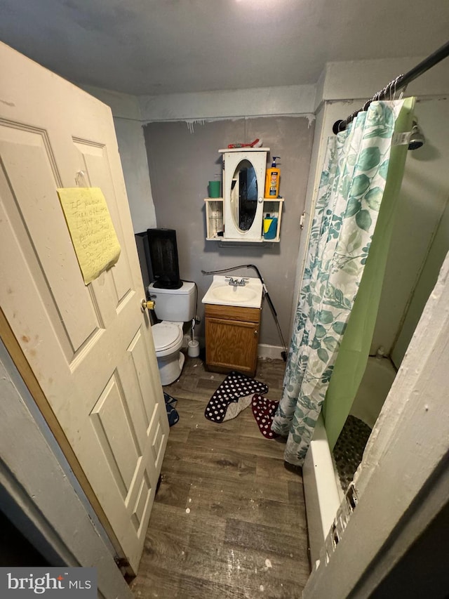 full bathroom featuring vanity, shower / bath combination with curtain, hardwood / wood-style flooring, and toilet