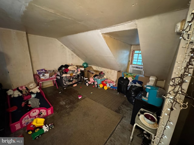 additional living space featuring cooling unit and vaulted ceiling