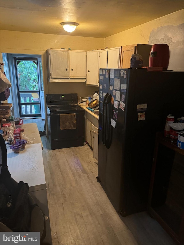 kitchen with black appliances and light wood-type flooring