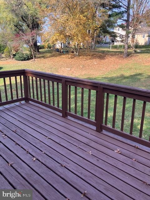 wooden terrace with a lawn