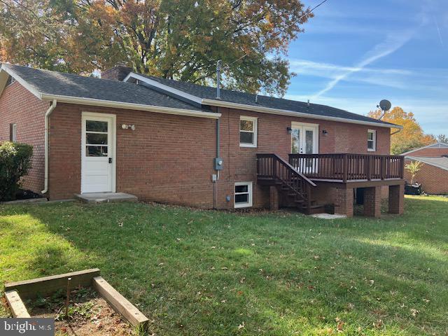 back of property with french doors, a yard, and a deck