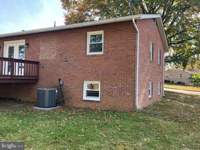 view of home's exterior featuring central AC and a lawn