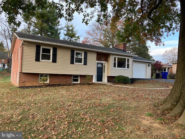 split foyer home with a front lawn and a garage