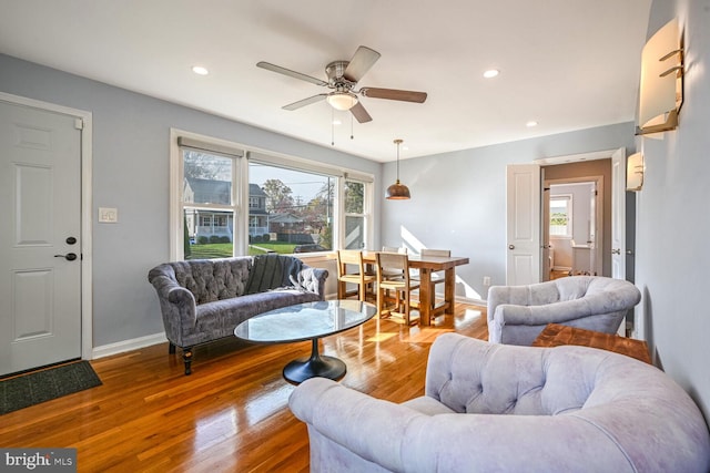 living room featuring hardwood / wood-style floors, a wealth of natural light, and ceiling fan