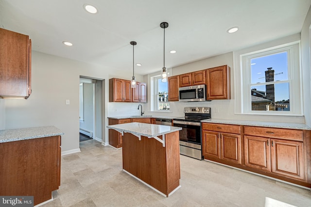kitchen with stainless steel appliances, brown cabinetry, a baseboard radiator, and a sink