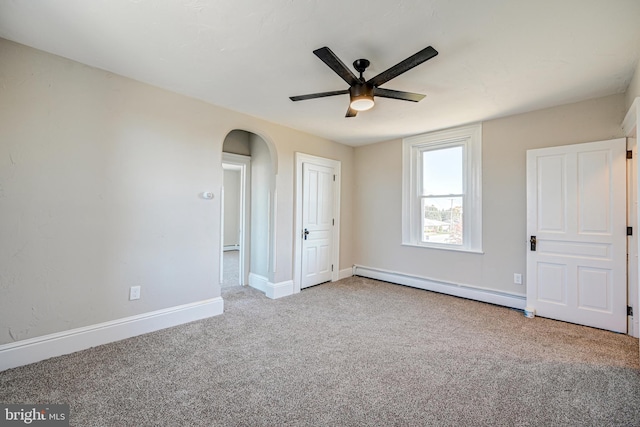 unfurnished bedroom with carpet floors, baseboards, ceiling fan, arched walkways, and a baseboard radiator