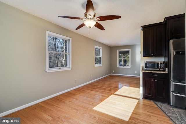 kitchen featuring ceiling fan, light hardwood / wood-style floors, and appliances with stainless steel finishes