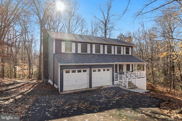 view of front of home featuring a porch and a garage