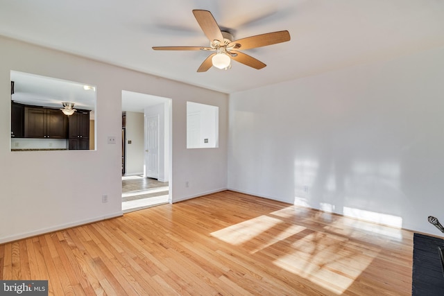 empty room with light hardwood / wood-style flooring and ceiling fan