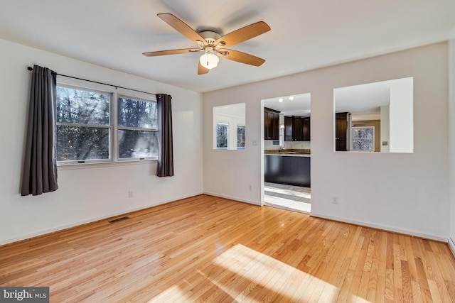 unfurnished room featuring ceiling fan and light wood-type flooring