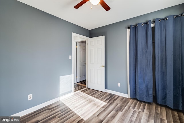 unfurnished bedroom featuring ceiling fan and hardwood / wood-style flooring