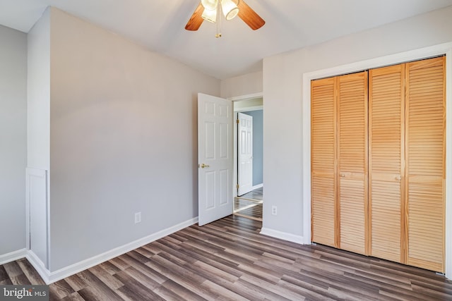 unfurnished bedroom featuring hardwood / wood-style floors, ceiling fan, and a closet