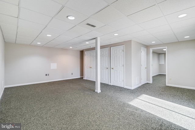 basement featuring carpet floors and a paneled ceiling