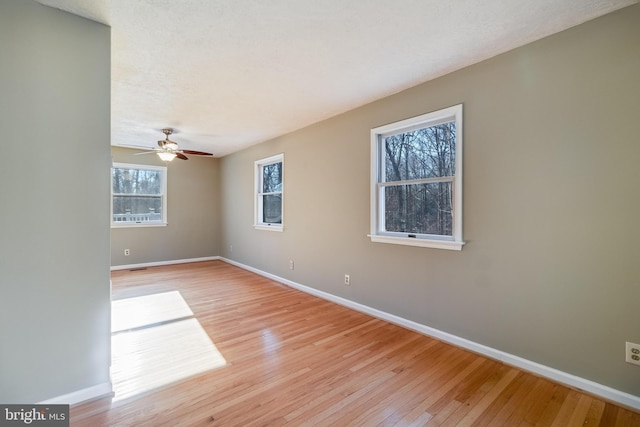 unfurnished room with ceiling fan and light hardwood / wood-style flooring