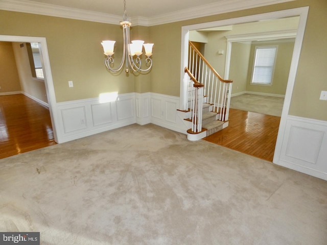 unfurnished dining area with light hardwood / wood-style flooring, a notable chandelier, and crown molding