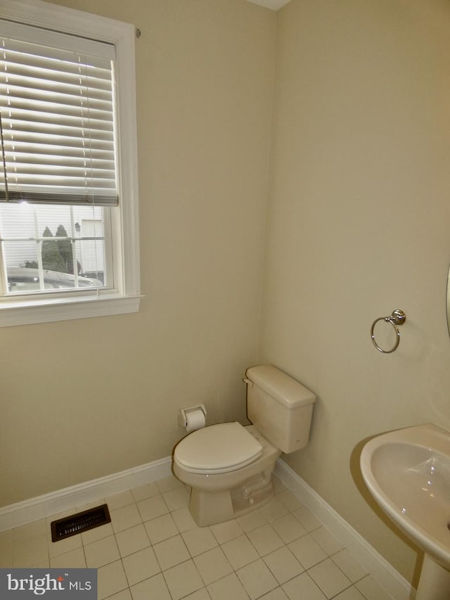 bathroom with tile patterned floors, toilet, and sink