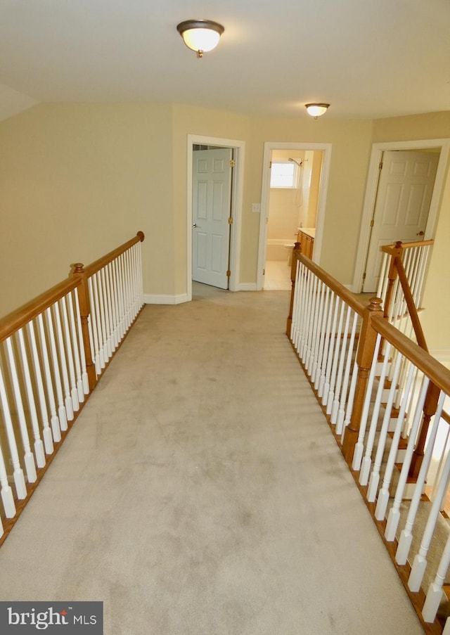 hallway with light colored carpet