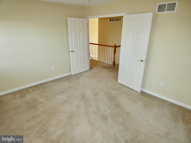 empty room with light colored carpet