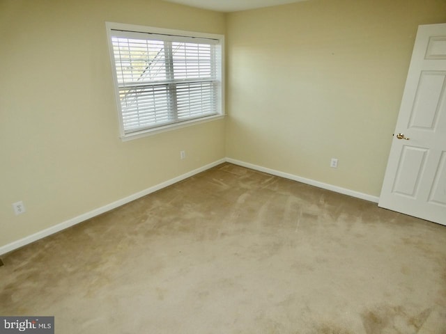 spare room with light colored carpet