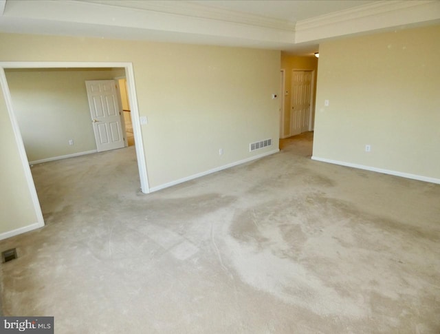 unfurnished room featuring light colored carpet and ornamental molding