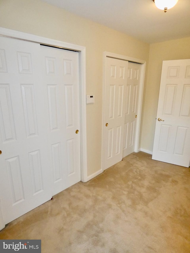 unfurnished bedroom with light colored carpet