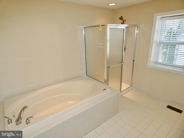 bathroom featuring tile patterned floors and shower with separate bathtub