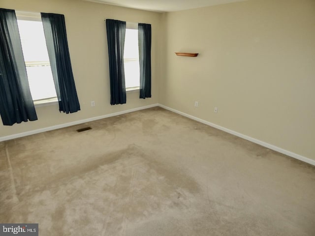 carpeted spare room with plenty of natural light