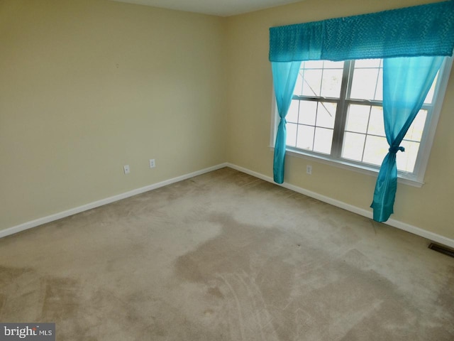 carpeted spare room with plenty of natural light