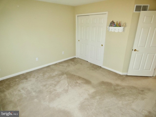 unfurnished bedroom featuring carpet and a closet