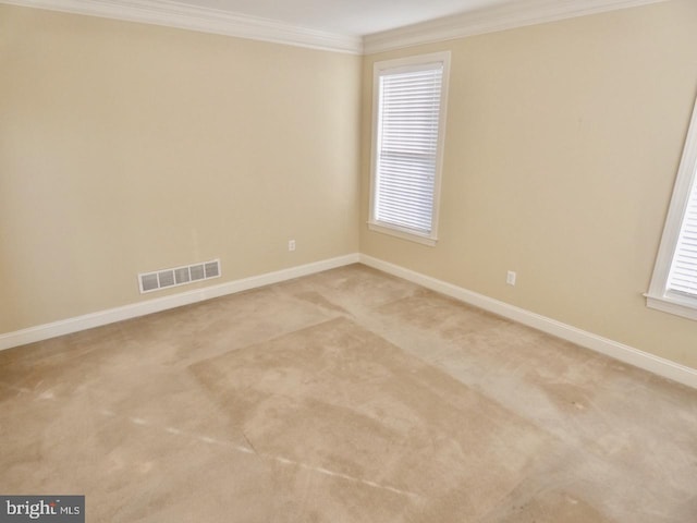 unfurnished room with ornamental molding and light carpet