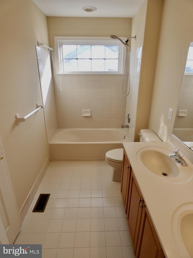 full bathroom with toilet, vanity, tile patterned floors, and tiled shower / bath