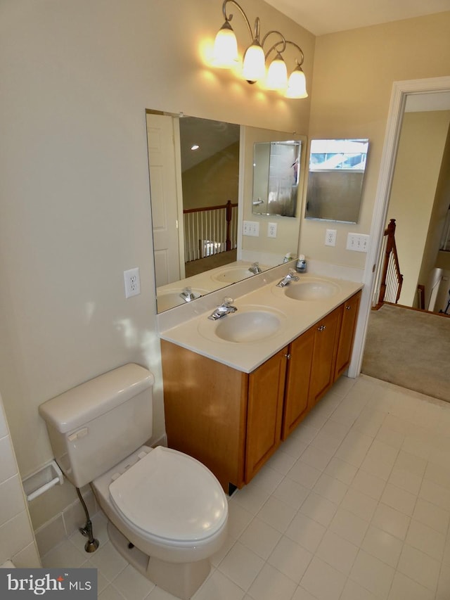 bathroom featuring tile patterned floors, vanity, and toilet