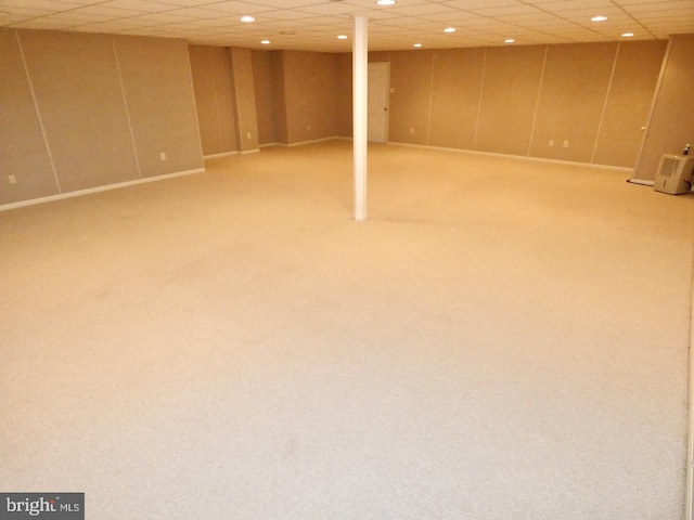 basement with carpet flooring and a drop ceiling