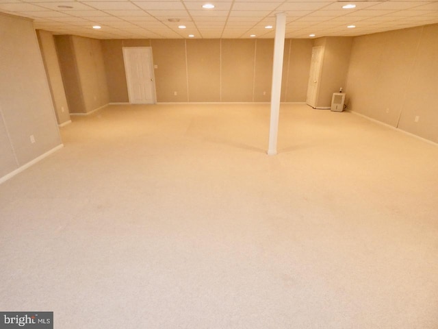 basement featuring carpet and a drop ceiling