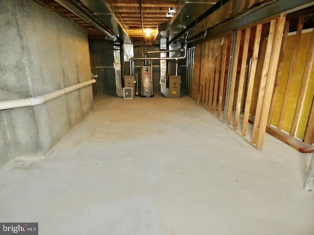 basement with water heater and heating unit