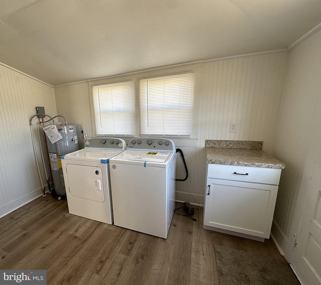 laundry room with cabinets, electric water heater, dark hardwood / wood-style flooring, ornamental molding, and wooden walls