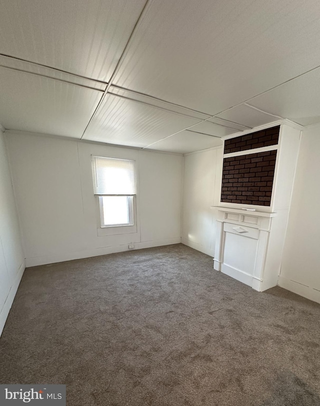 interior space with carpet and a large fireplace