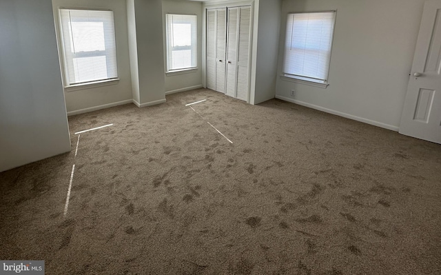 unfurnished bedroom featuring light carpet