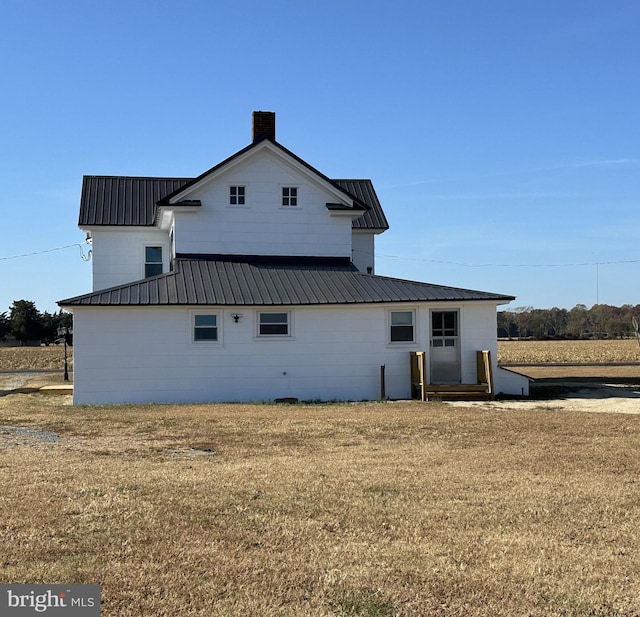 back of property with a lawn