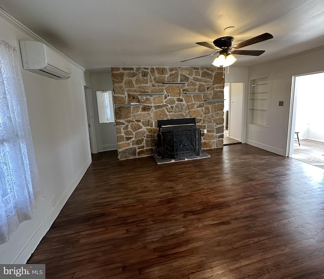 unfurnished living room with a stone fireplace, a wall unit AC, dark hardwood / wood-style floors, and ceiling fan