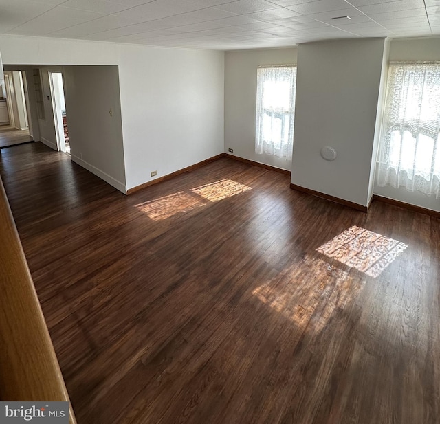 empty room with dark hardwood / wood-style flooring