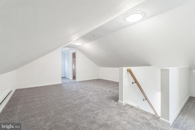 additional living space featuring lofted ceiling, carpet floors, and a baseboard radiator