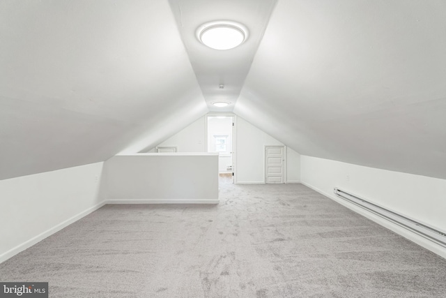 bonus room featuring light carpet, baseboard heating, and vaulted ceiling