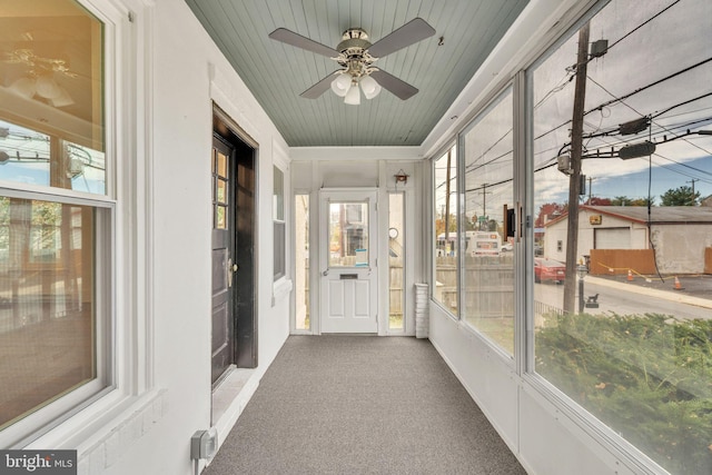 unfurnished sunroom with wood ceiling and a healthy amount of sunlight