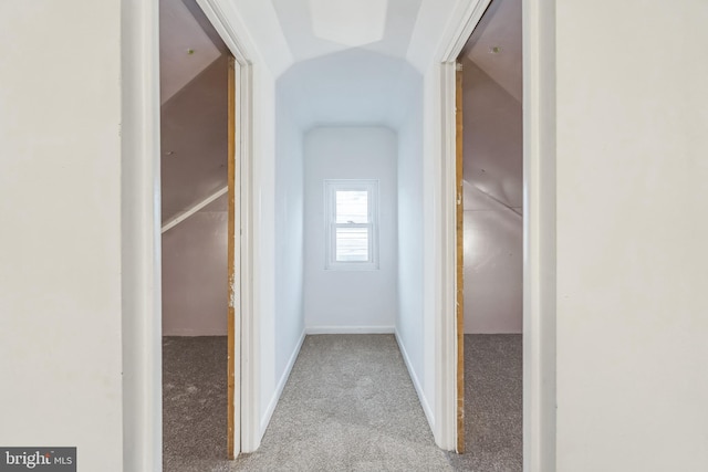 hall featuring light carpet and lofted ceiling