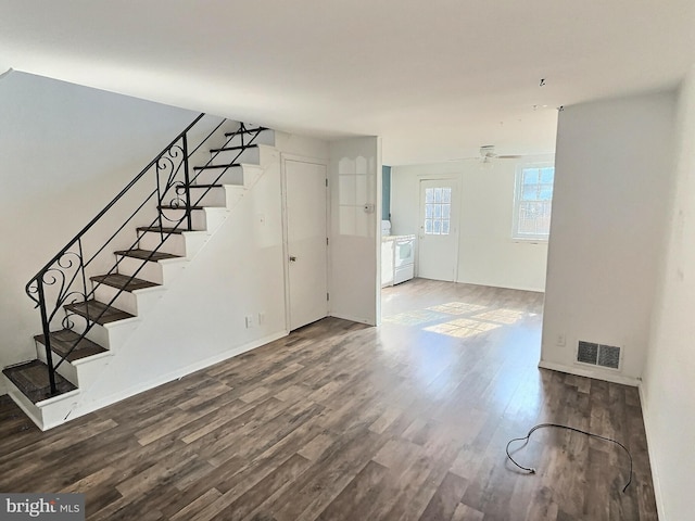 unfurnished living room featuring ceiling fan and wood-type flooring