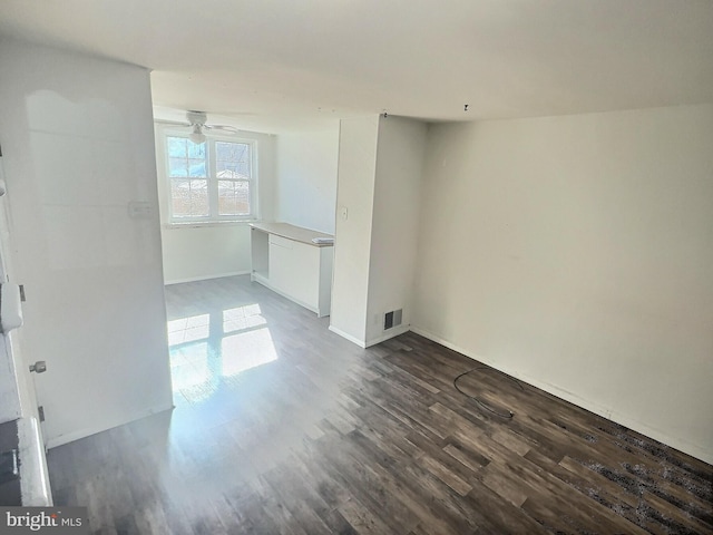 spare room featuring ceiling fan and dark hardwood / wood-style floors