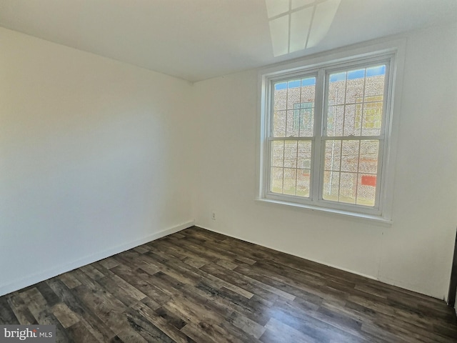 unfurnished room featuring dark wood-type flooring