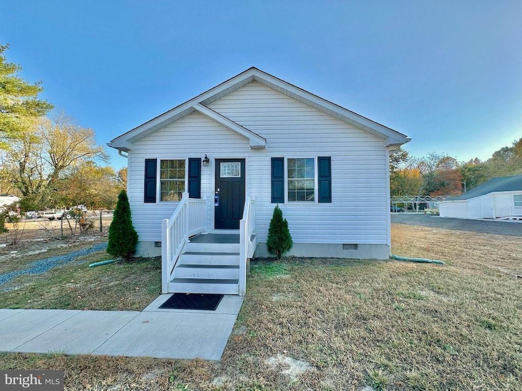 bungalow-style house with a front yard